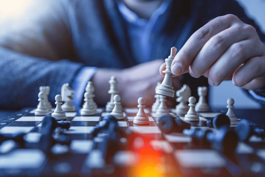 A man playing chess, signifying the strategic thinking required for using AI in business.