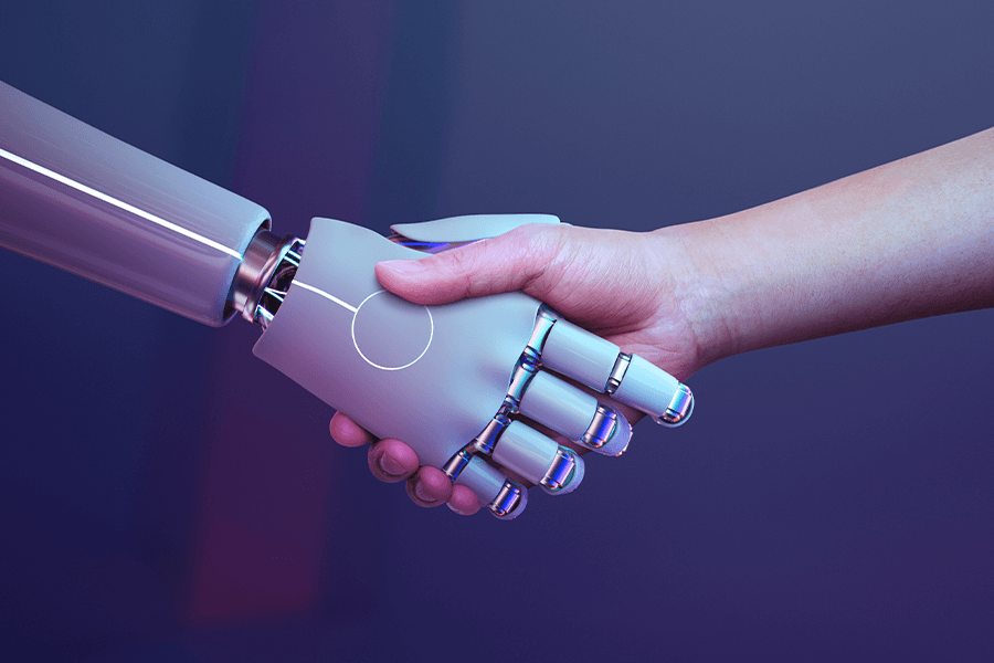 A human hand shakes with a robot hand to symbolize the power of Artificial Intelligence.
