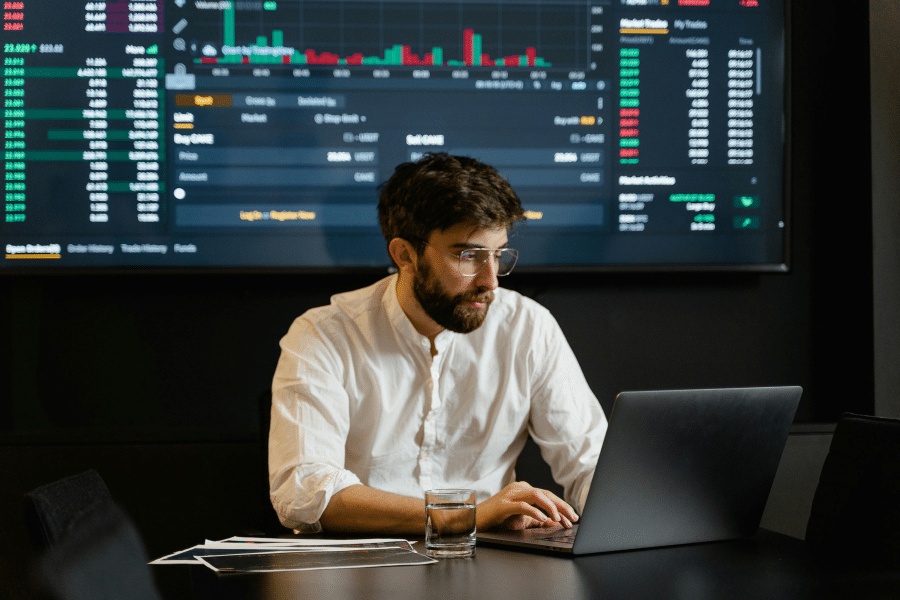 A data analyst working on his laptop to develop a data strategy