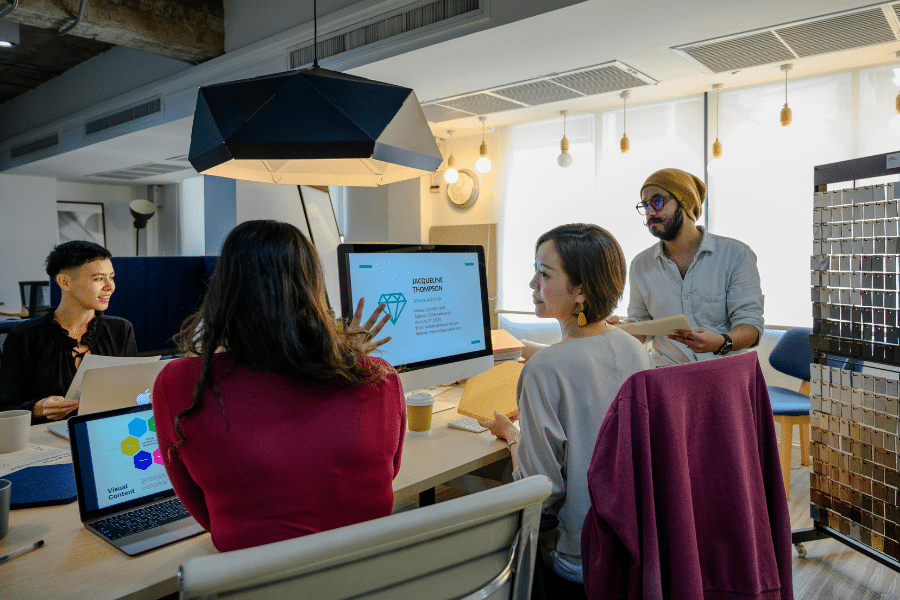 People in a team gathering over reports